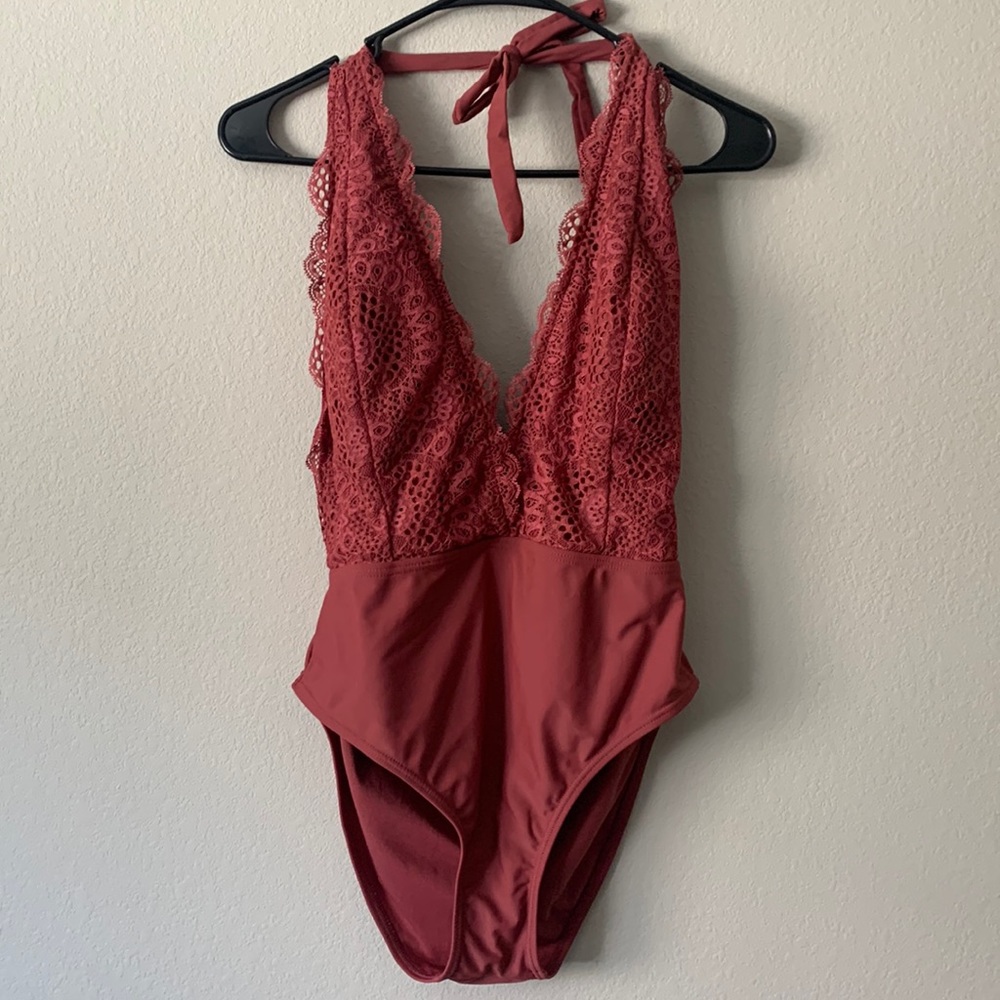 Deep V dusk colored one piece with lace detailing.